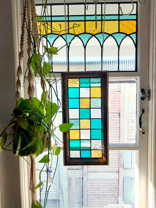 Timber framed patchwork in teal and yellow.