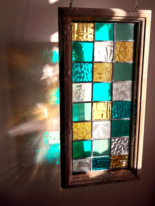 Timber framed patchwork in teal and yellow.