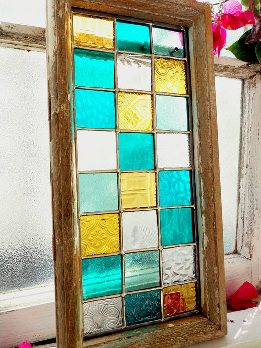 Timber framed patchwork in teal and yellow.