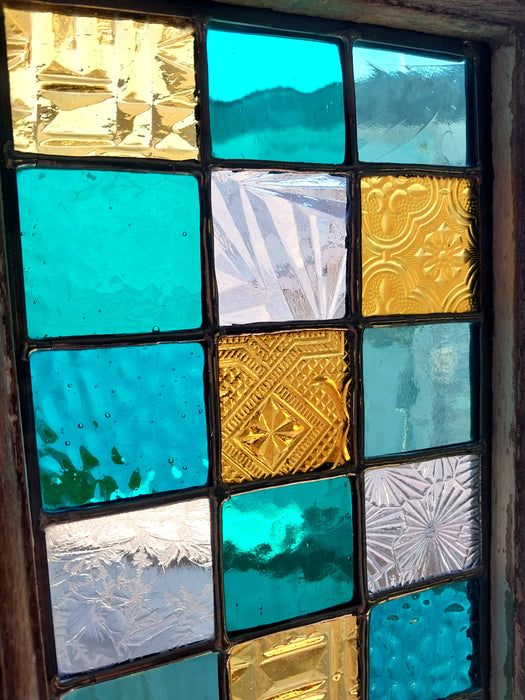 Timber framed patchwork in teal and yellow.