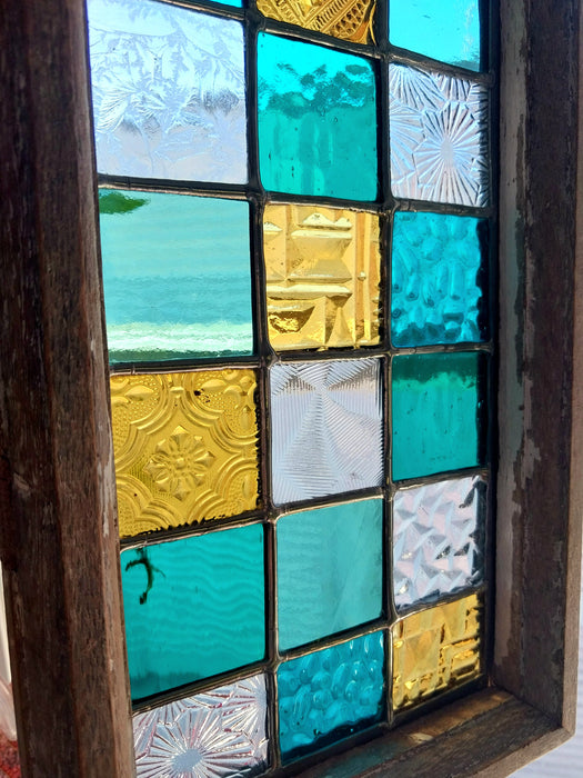 Timber framed patchwork in teal and yellow.