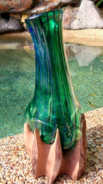 Molten teal blue and green mouthblown glass vase in timber stand.