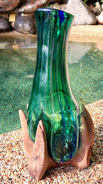 Molten teal blue and green mouthblown glass vase in timber stand.
