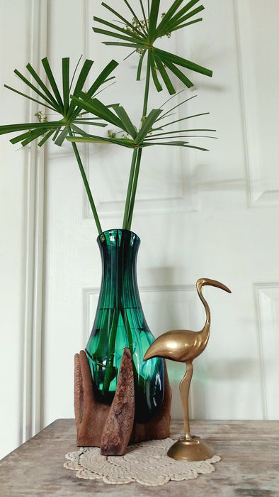 Molten teal blue and green mouthblown glass vase in timber stand.